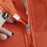 نیم تنه ورزشی زنانه ملییلدا مدل جلو زیپدار پد ثابت کد 5018 رنگ نارنجی